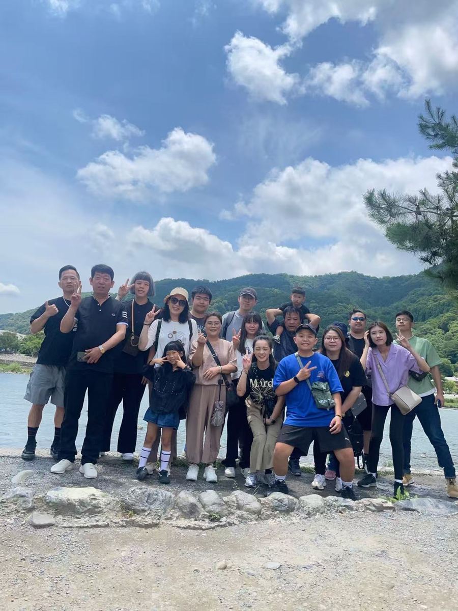 Group under a summer sky at Arashiyama